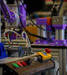 Close-up of industrial automation setup with control panel and machinery parts.