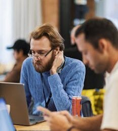 Focused professionals collaborating in a modern office setting, highlighting teamwork and technology.